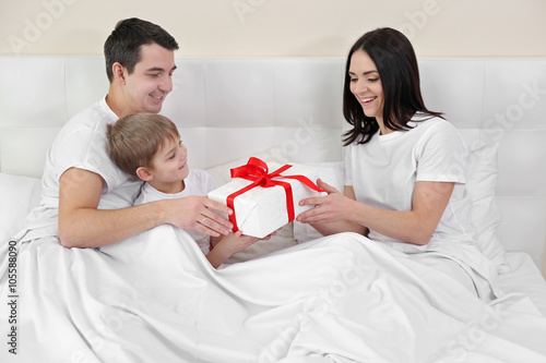Husband and son giving pres...