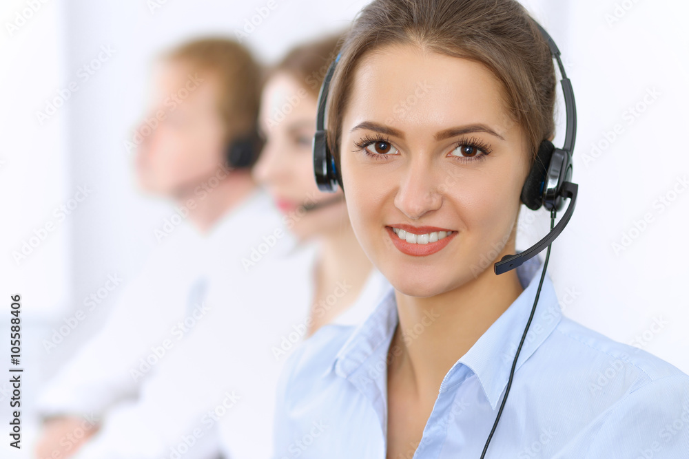 Call center. Focus on beautiful woman in headset Call center. Focus on beautiful woman in headset