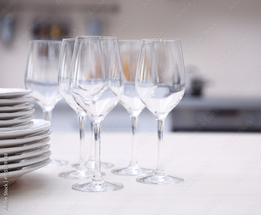 Prepared clean dishes for dinner party on a table in the kitchen Prepared clean dishes for dinner party on a table in the kitchen