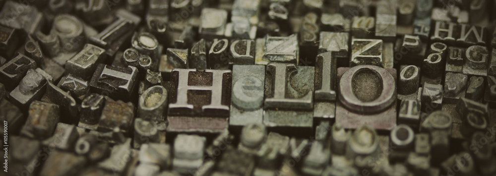 Naklejka premium Close up of typeset letters with the word Hello