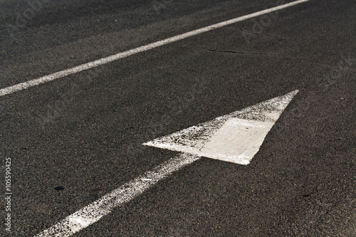 Line and arrow on asphalt surface