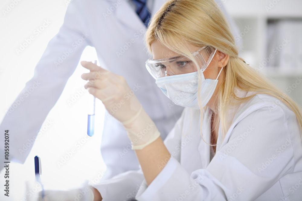 Scientific research team with clear solution in laboratory Scientific research team with clear solution in laboratory