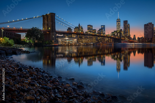 Brooklyn Bridge and Manhattan skyline in New York City over the East River at night