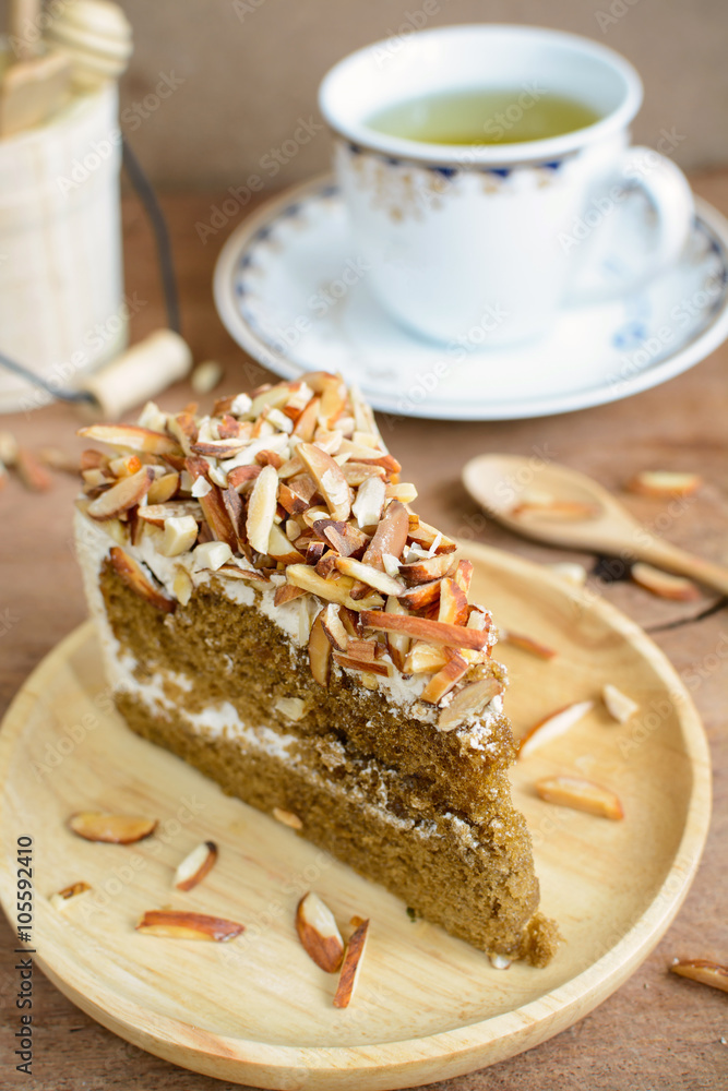 Coffee cake with almonds on top and cup of tea Coffee cake with almonds on top and cup of tea