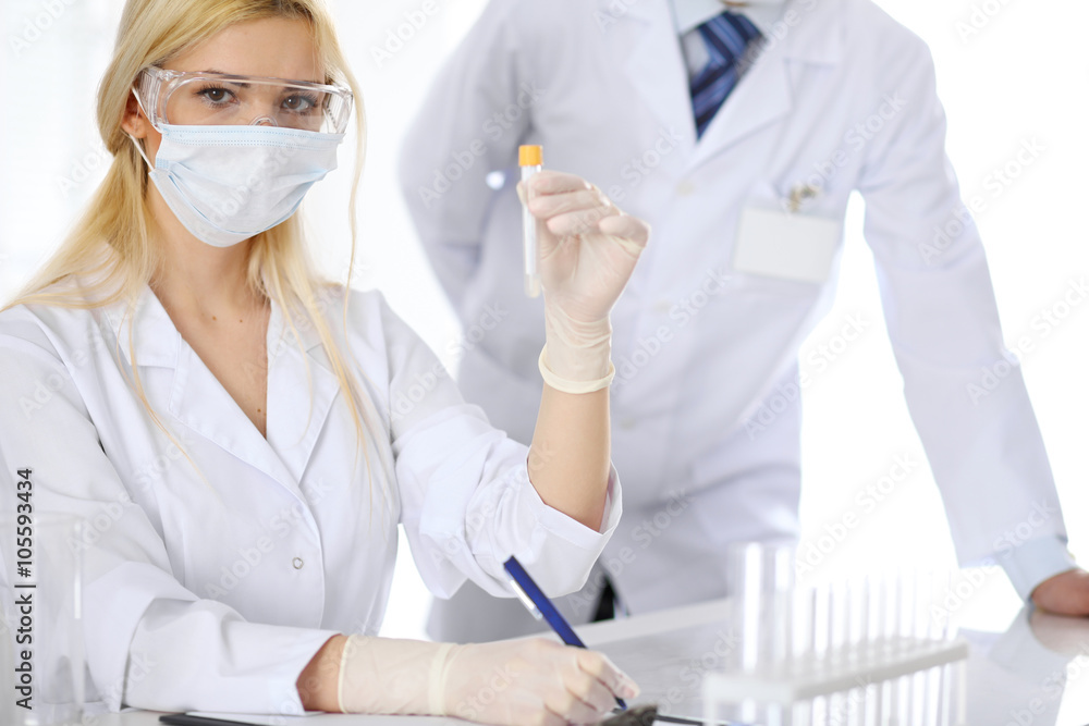 Scientific research team with clear solution in laboratory Scientific research team with clear solution in laboratory