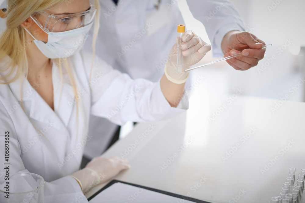 Scientific research team with clear solution in laboratory Scientific research team with clear solution in laboratory