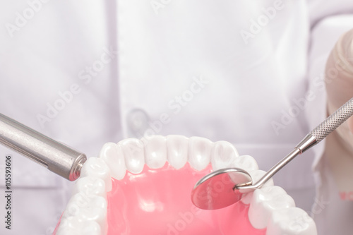 Dentist over open patient's mouth looking in teeth