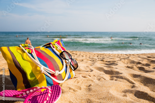 Women's beach accessories on the sandy shore