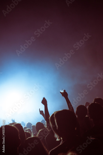 Beer and hands in the air during a live electronic techno concert in a pop venue