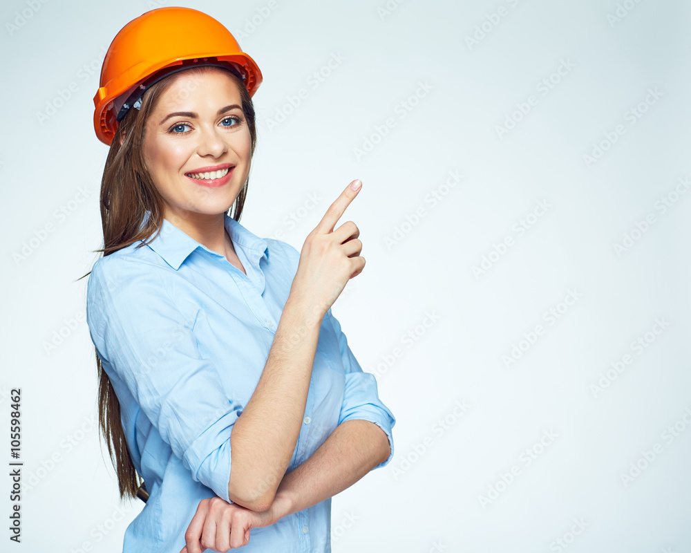 © Yuriy Shevtsov - Smiling woman builder pointing finger on copy space. © Yuriy Shevtsov - Smiling woman builder pointing finger on copy space.