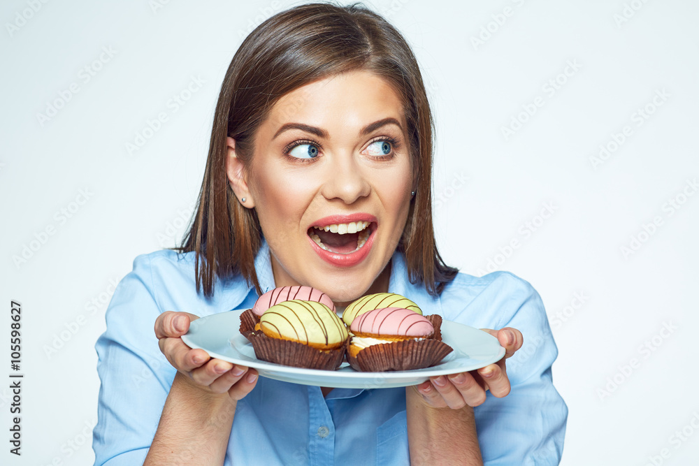 Woman holding plate with cookies and she wants to eat them. Woman holding plate with cookies and she wants to eat them.