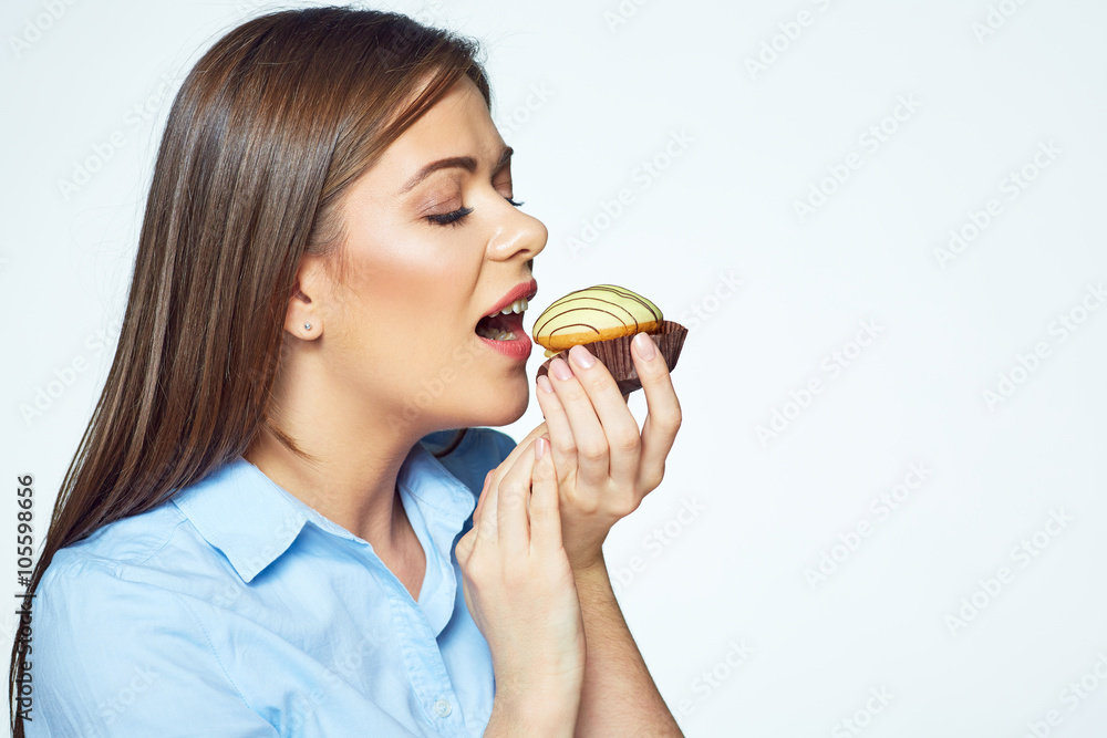 Young woman biting french cookie. Close up face portrait Young woman biting french cookie. Close up face portrait