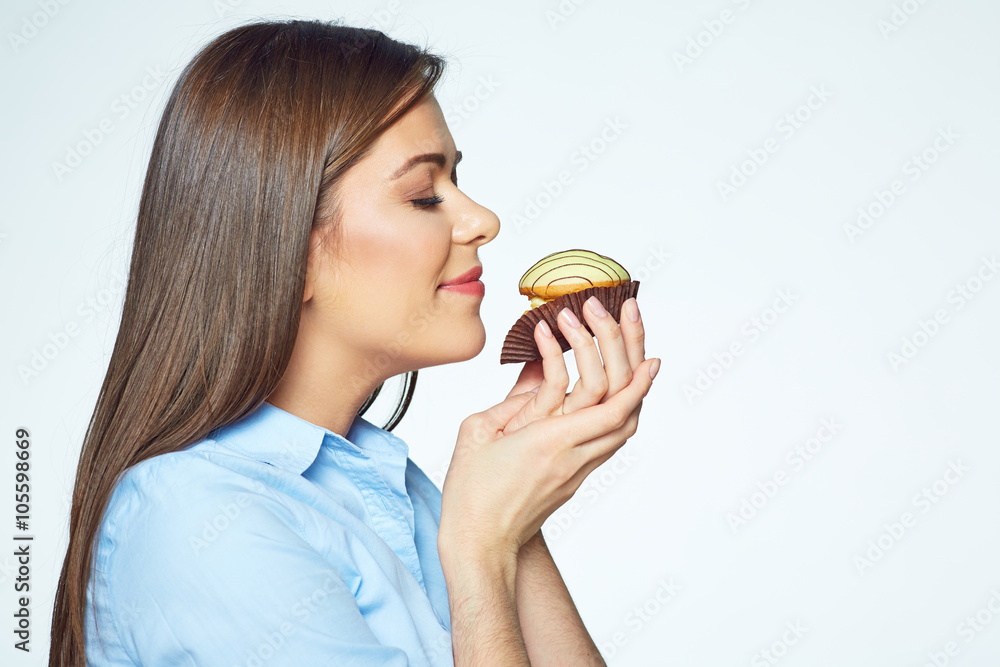Young woman enjoying smell of cookies with closed eyes Young woman enjoying smell of cookies with closed eyes