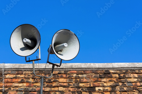 Two bullhorn on the roof with space on blue sky