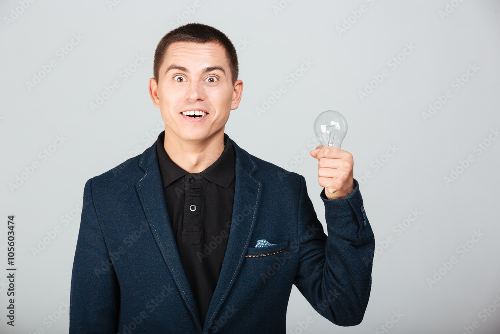 Concept image of a businessman holding bulb