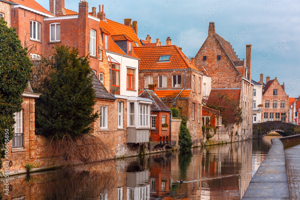 Scenic city view of Bruges canal with beautiful medieval houses and their reflection, Belgium
