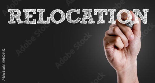 Hand writing the text: Relocation