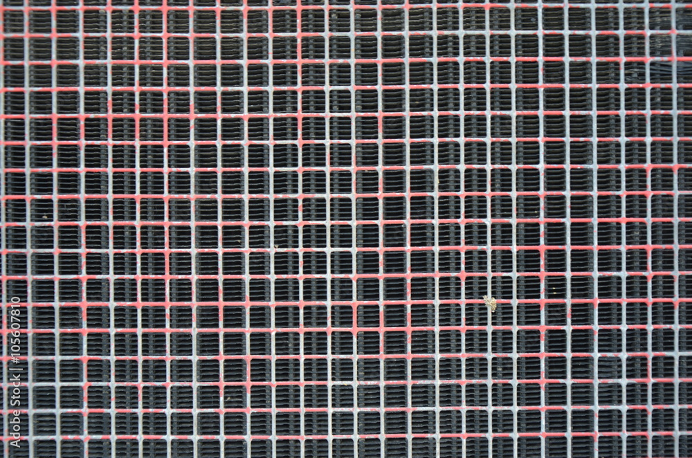 Old pink white wire mesh on black background Old pink white wire mesh on black background