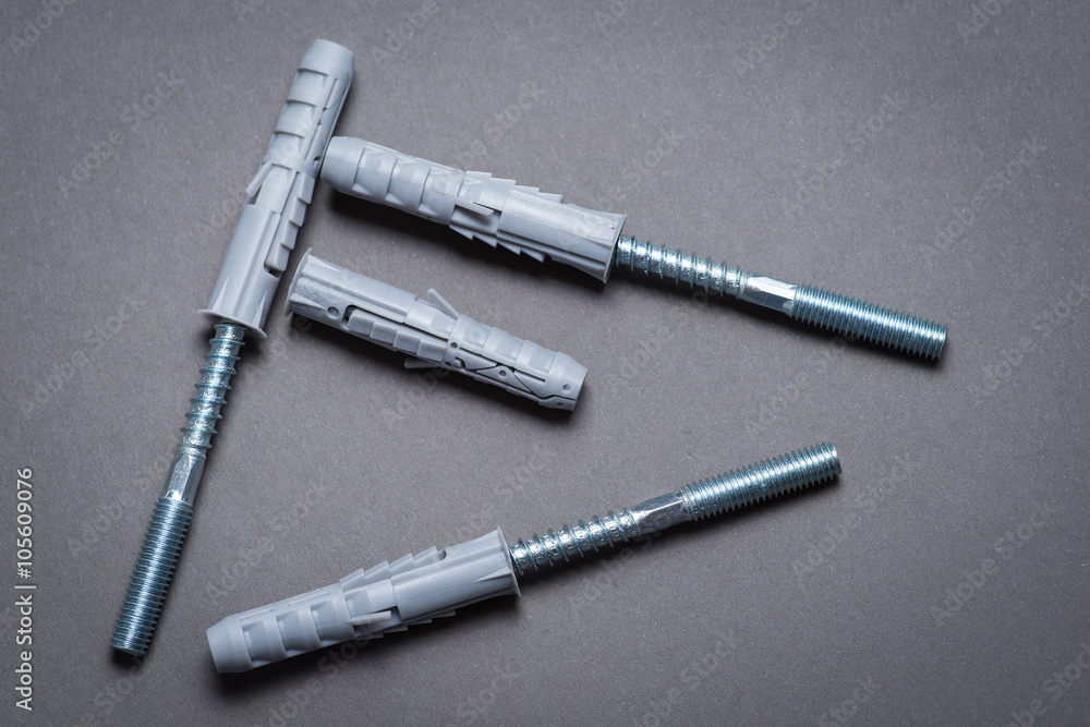 Fototapeta premium Plastic dowels and screws on dark grey surface