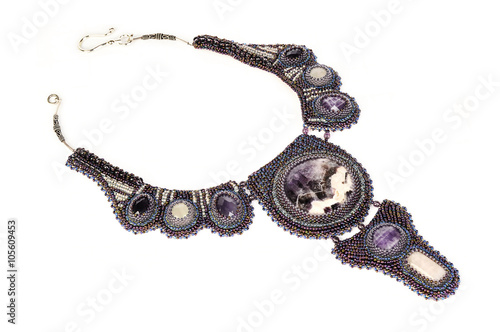 violet beaded necklace with stones, handmade isolated on white b