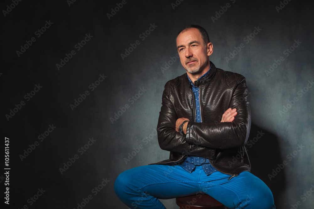 seated mature man in leather jacket seated mature man in leather jacket