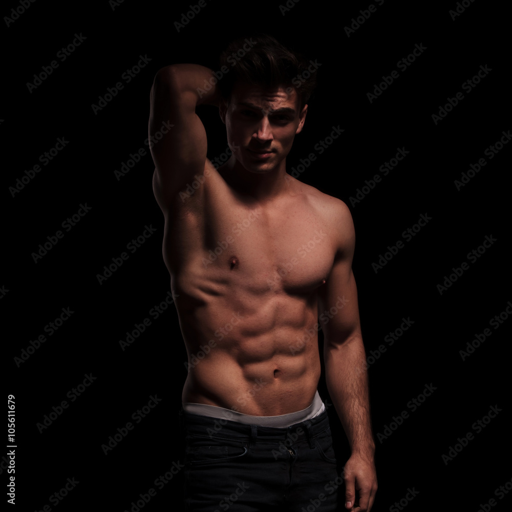 Fototapeta premium topless, muscular man raising his arm