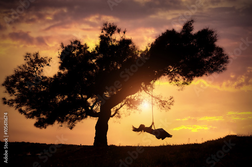 Fototapeta woman silhouette on swing