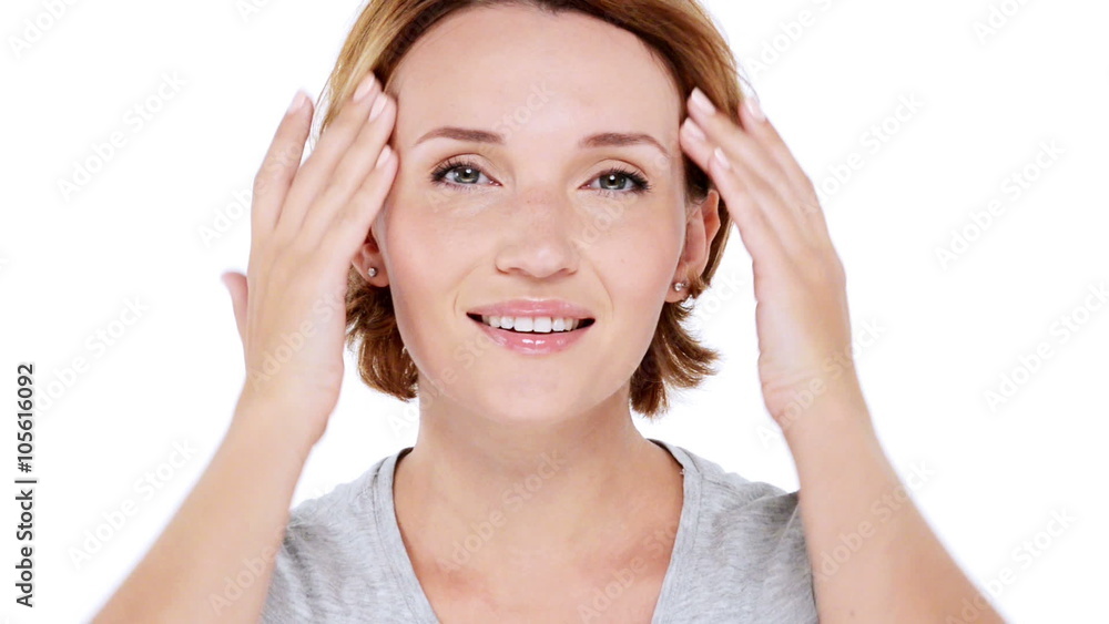 Beautiful smiling woman pampering skin of face over white background Beautiful smiling woman pampering skin of face over white background