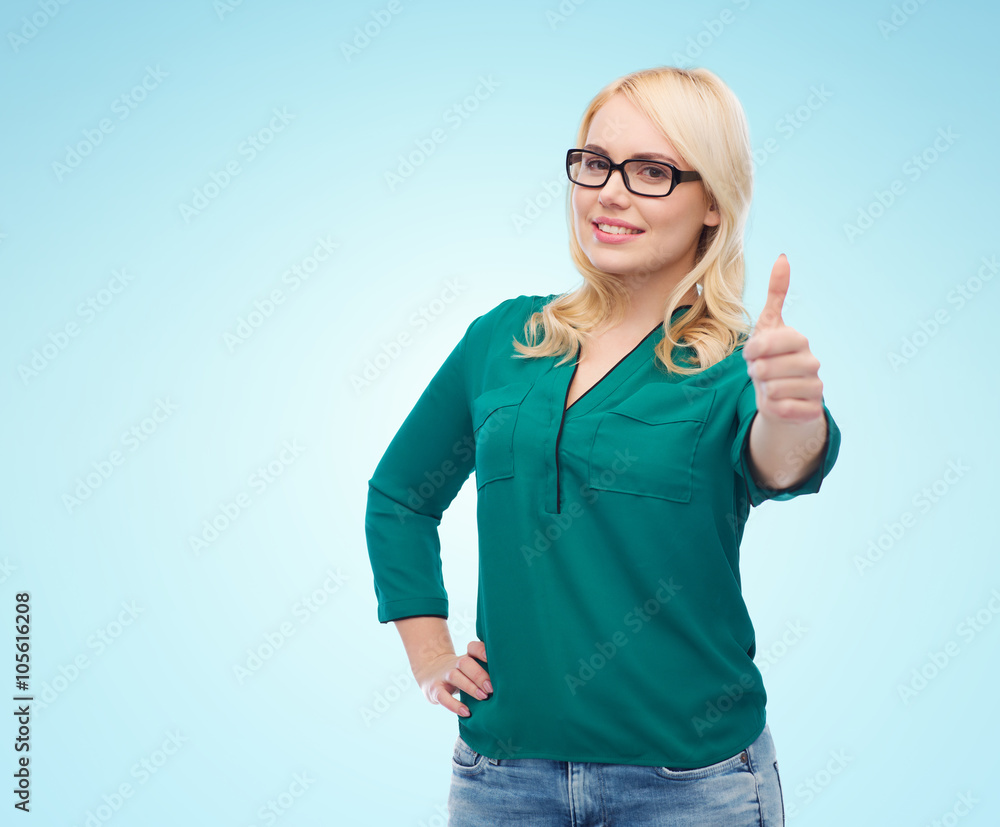young woman in eyeglasses showing thumbs up young woman in eyeglasses showing thumbs up