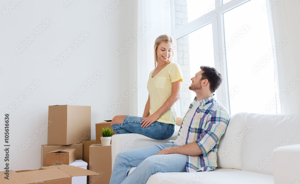 happy couple with big cardboard boxes at new home happy couple with big cardboard boxes at new home
