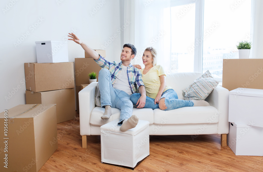 couple with boxes moving to new home and dreaming couple with boxes moving to new home and dreaming