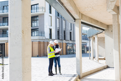 Engineer and Architect checking last details on a construction s © Production Perig