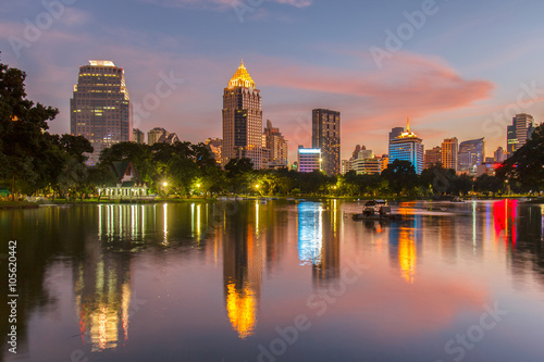 Business district cityscape from a park with Twilight Time from Lumpini Park  Bangkok  Thailand