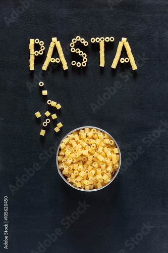 Pasta slogan written with italian tubetti type on dark background