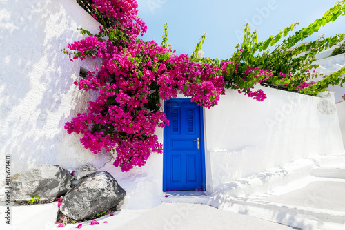 Traditional greek house with bougainvillaea on Santorini island, photo