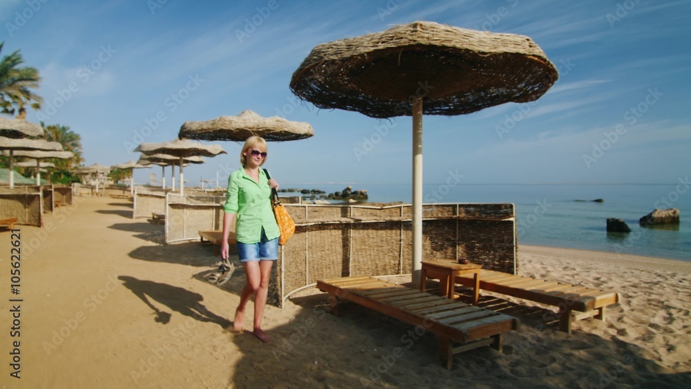 Steadicam shot: Young woman walking on the beach Steadicam shot: Young woman walking on the beach