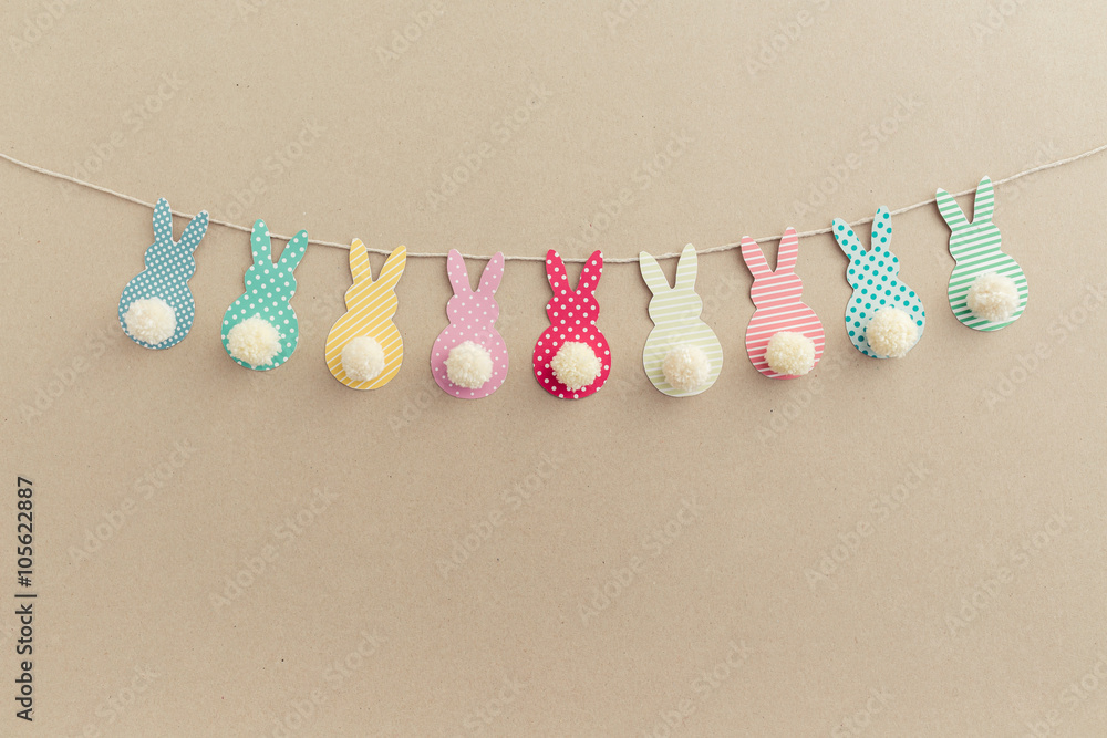 Obraz premium Easter Bunny Banner. Cute bunny shapes with yarn pom pom tails.