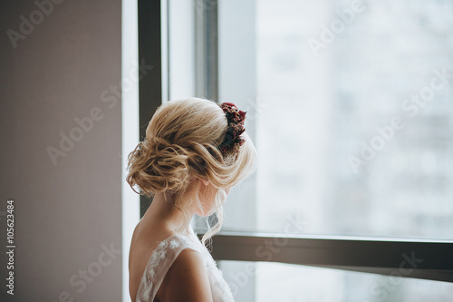 Wedding. Bride. Preparation. The bride in a white dress and a wreath on his head standing and looking out the window Free Download Wedding. Bride. Preparation. The bride in a white dress and a wreath on his head standing and looking out the window - GFXLoad