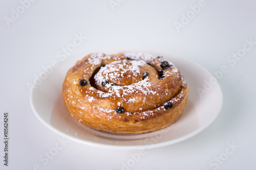 sweet bun with raisins over white