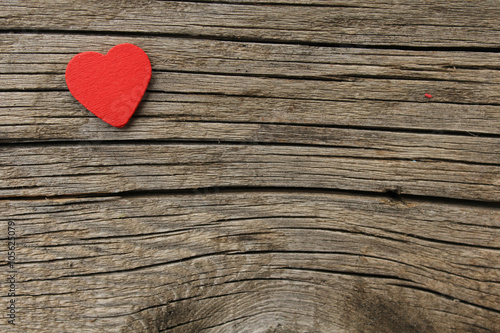 Red heart on wooden background with space for text - valentines day concept 