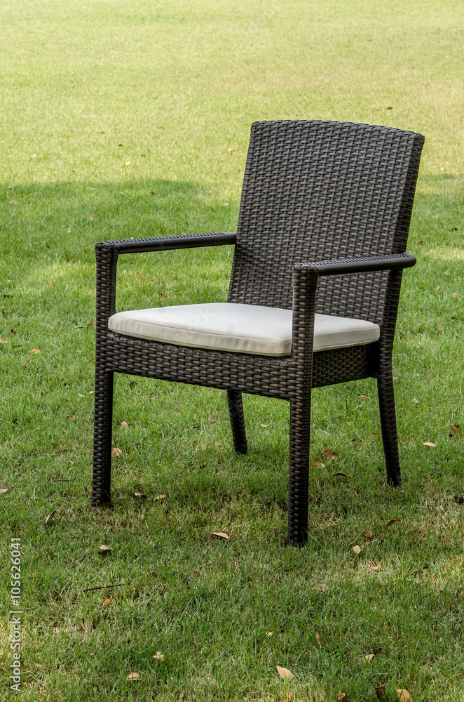 Rattan chair with cushion in the garden Rattan chair with cushion in the garden