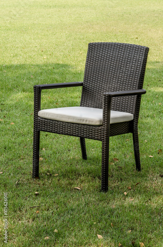 Rattan chair with cushion in the garden © praethip