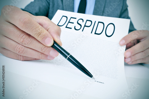 man shows a document with the text despido, dismissal in spanish