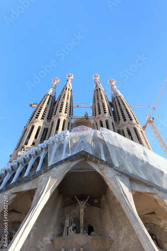 Passion facade at church Sagrada Familia with towers in Barcelona, Spain