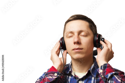 young man listening to music with headphones on white background