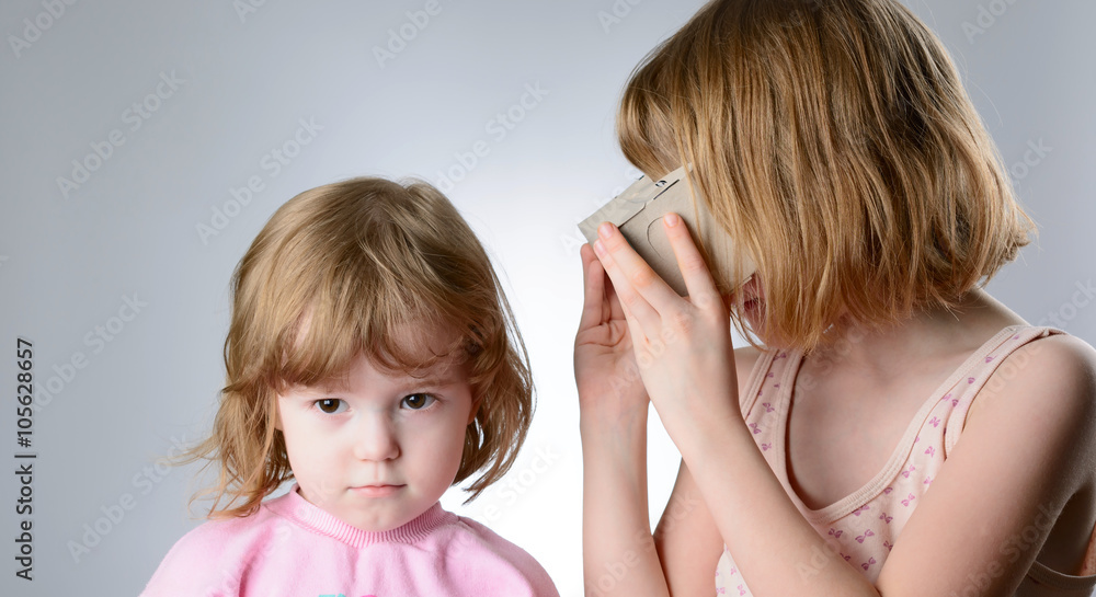 Two girls are playing with virtual reality glasses Two girls are playing with virtual reality glasses