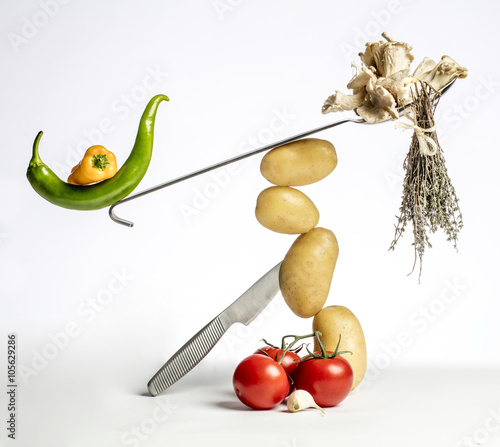 gourmet food composition with colorful vegetables and modern kitchen utensils isolated on white background for fun gastronomy and vegetarian recipe