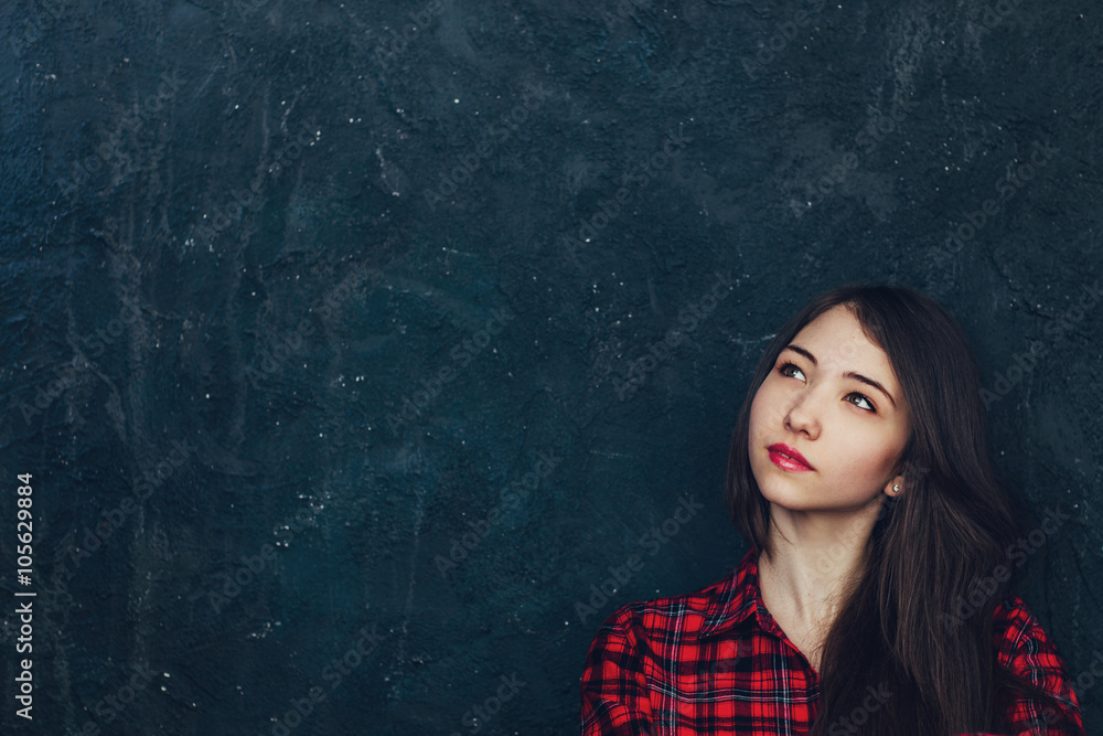 beautiful girl stands near the wall in the Studio beautiful girl stands near the wall in the Studio