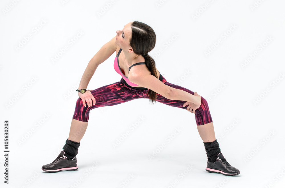 sporty girl in pink form doing exercises isolated on white background