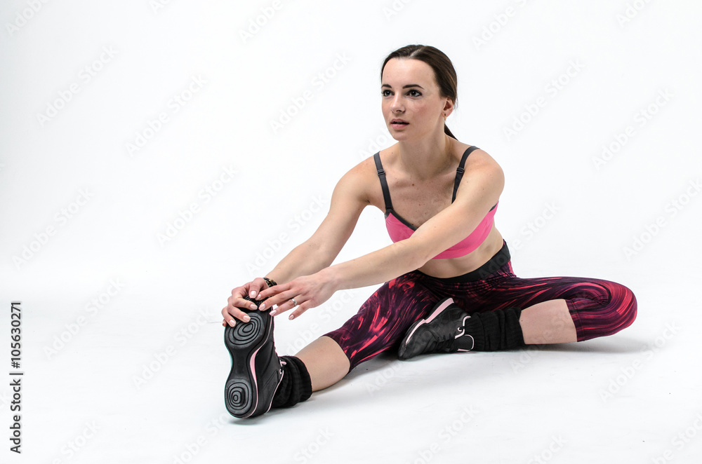 Fototapeta premium sporty girl in pink form doing exercises isolated on white background